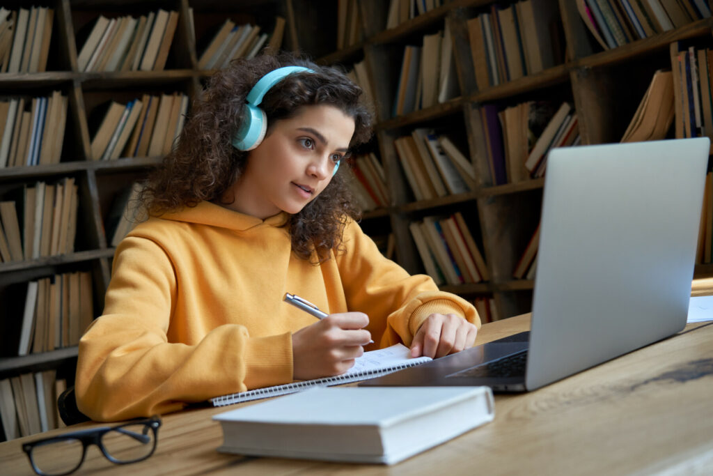 student on laptop with headphones